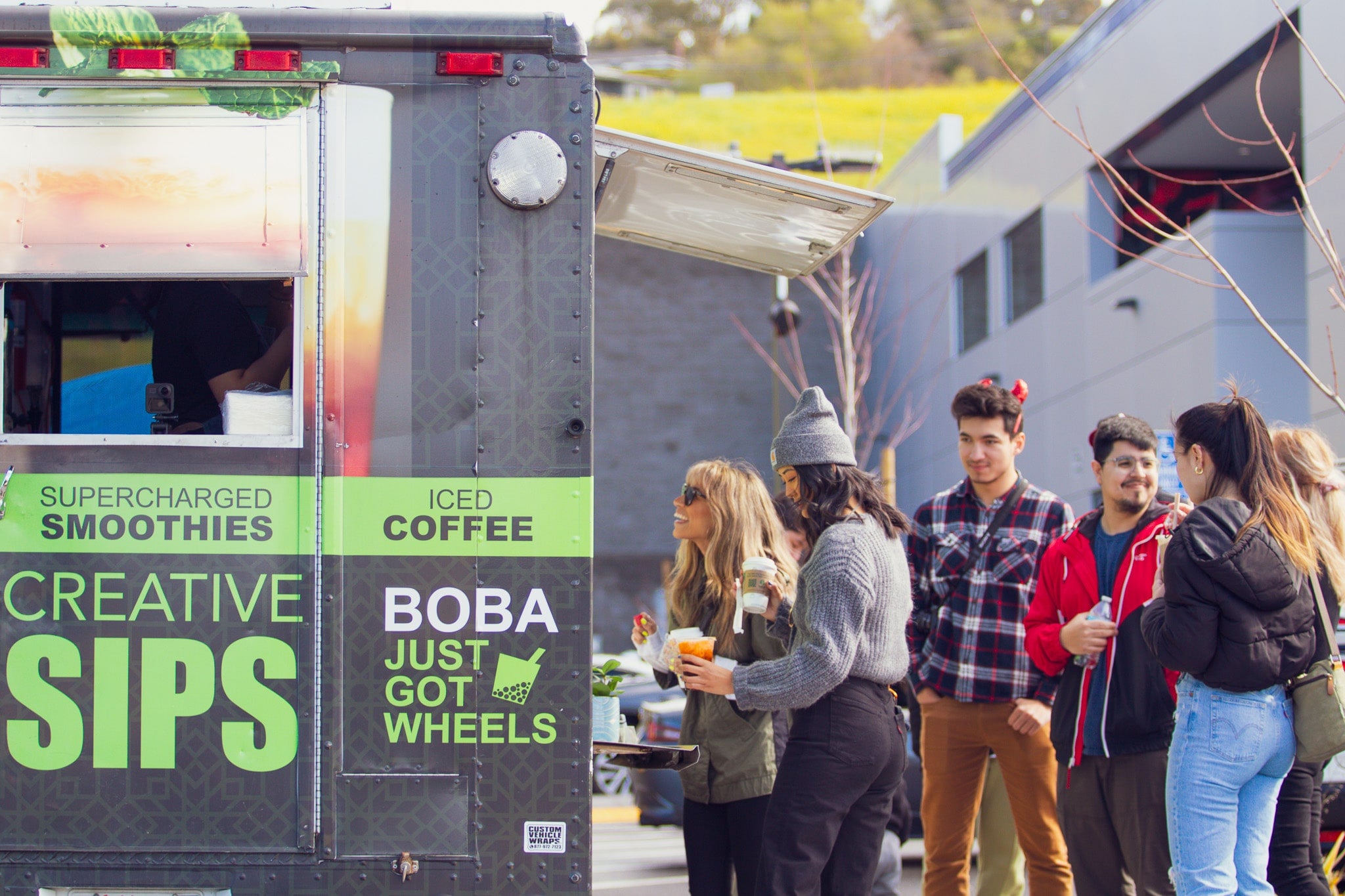 Customers ordering drinks from food truck